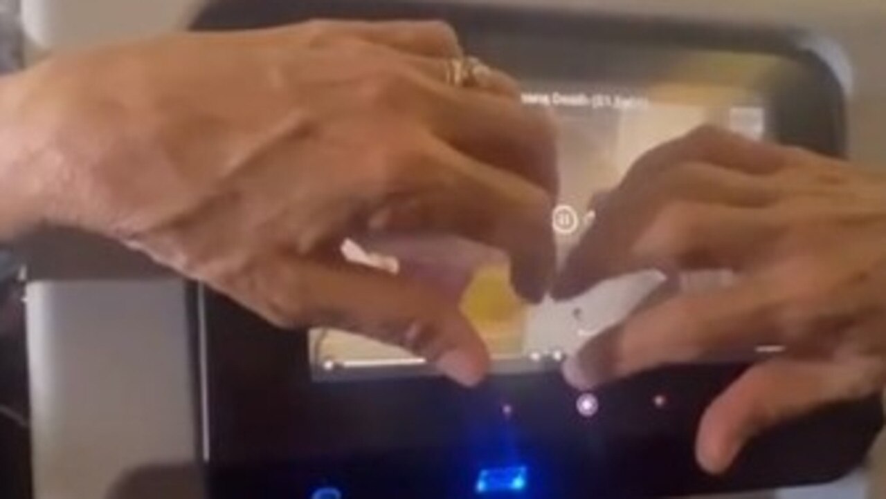 This plane passenger was filmed touching the screen behind their seat on a long haul flight. Picture: Reddit