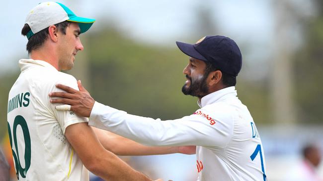 Pat Cummins shakes hands with Sri Lanka's captain Dimuth Karunaratne after the crushing defeat. Picture: AFP