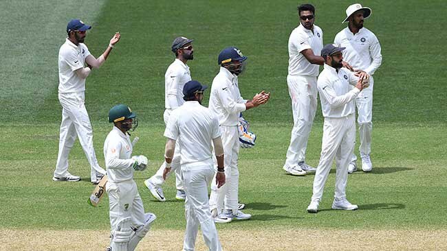 Usman Khawaja prepares to leave the pitch as India’s players appeal for a review. Picture: AAP