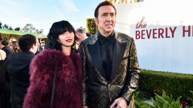 Riko Shibata and Nicolas Cage pictured before they were stranded on the naughty stairs. Picture: Alberto Rodriguez