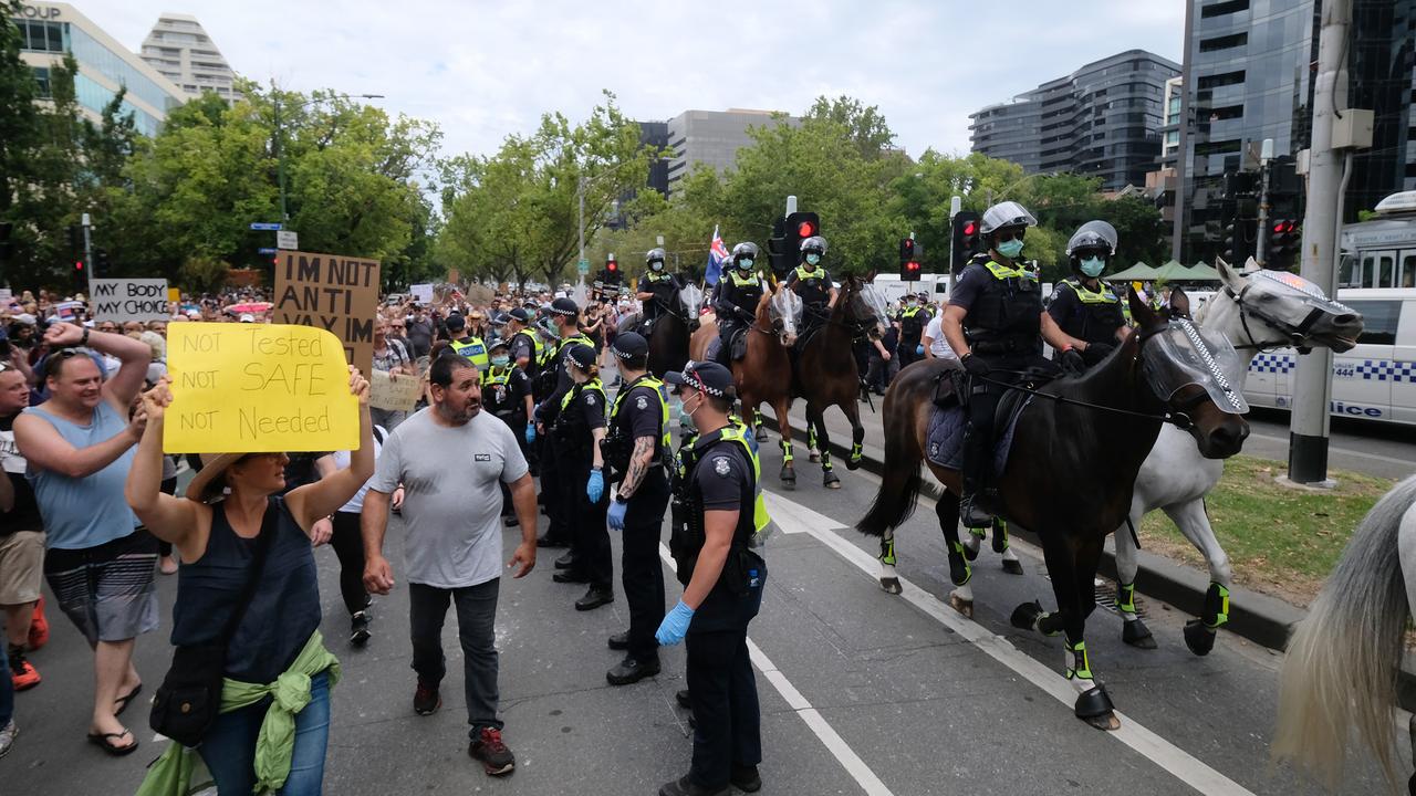 Protesters rally against 'mandatory' COVID-19 vaccinations in Melbourne on Saturday. Picture: Luis Ascui/Getty Images