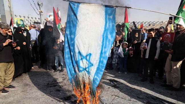 Iranians burn an Israeli flag during a rally in Tehran after Iran fired a barrage of nearly 200 missiles at the Jewish state. Picture: AFP