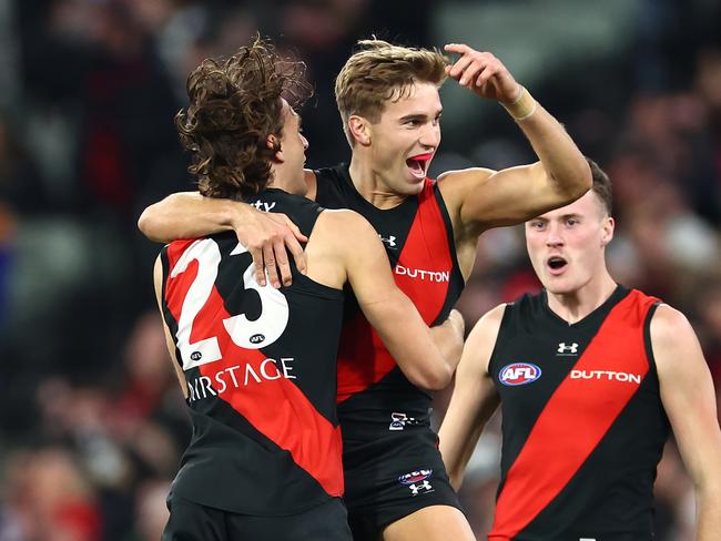 MELBOURNE, AUSTRALIA - JULY 05: Matt Guelfi of the Bombers is congratulated by team mates after kicking a goal during the round 17 AFL match between Collingwood Magpies and Essendon Bombers at Melbourne Cricket Ground, on July 05, 2024, in Melbourne, Australia. (Photo by Quinn Rooney/Getty Images)