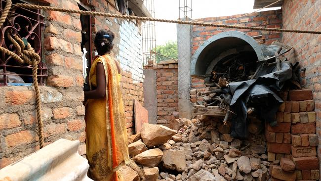 One of the women enters the “classroom” where the children learn and their mothers sew. Photo: Whitney Taylor