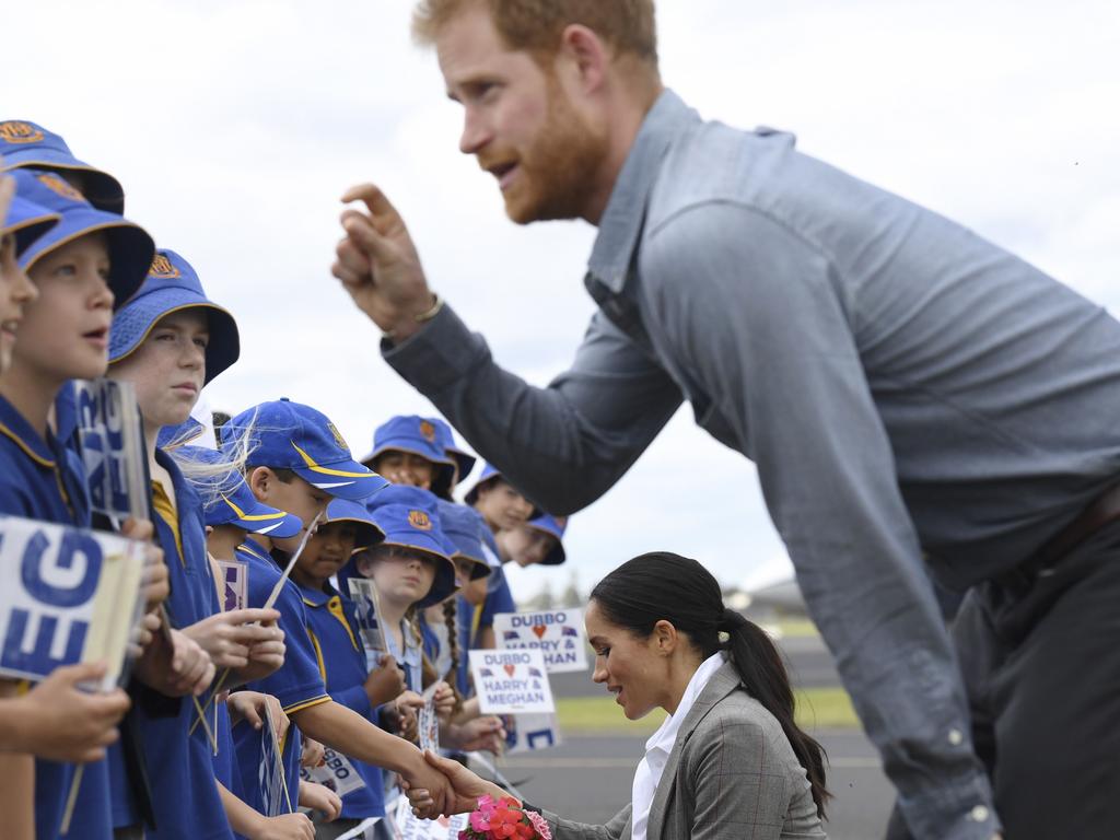 Always a jokester, Prince Harry is probably explaining something funny here. Picture: Dean Lewins/AFP