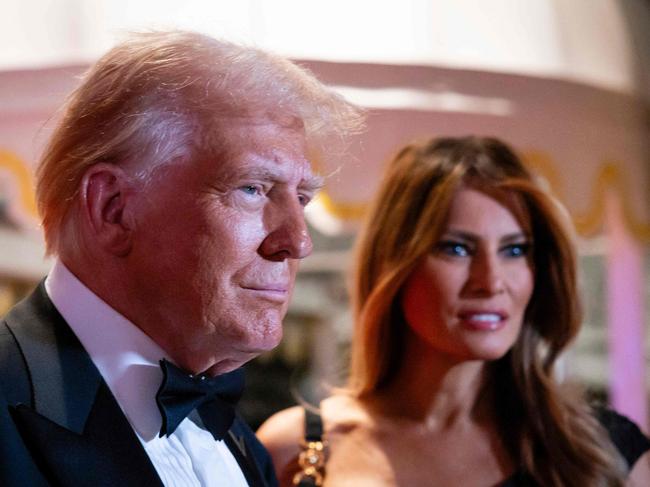 PALM BEACH, FLORIDA - DECEMBER 31: U.S. President-elect Donald Trump and his wife Melania Trump arrive on New Year's Eve at his Mar-A-Lago Club on December 31, 2024 in Palm Beach, Florida. Trump continues to fill posts in his upcoming administration ahead of his January 20 inauguration.   Eva Marie Uzcategui/Getty Images/AFP (Photo by Eva Marie Uzcategui / GETTY IMAGES NORTH AMERICA / Getty Images via AFP)