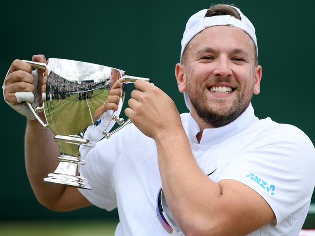 LONDON, ENGLAND - JULY 13: Dylan Alcott of Australia lifts the winners trophy after celebrating victory in the Men's Quad Wheelchair Singles final against Andy Lapthorne of Great Britain during Day twelve of The Championships - Wimbledon 2019 at All England Lawn Tennis and Croquet Club on July 13, 2019 in London, England. (Photo by Matthias Hangst/Getty Images)