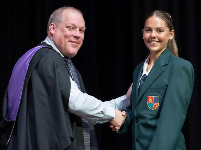 St Luke’s Anglican School 2025 School Captain Alexandria accepts the title, shaking hands with principal Matthew Hughes. Image credit: St Luke’s Anglican School