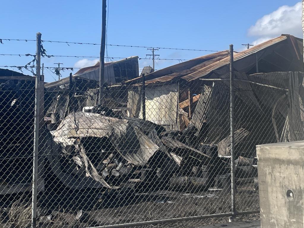 Police are standing guard after a large fire destroyed an industrial shed in West Mackay. Picture: Zoe Devenport