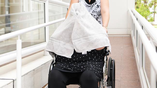 Gabrielle Mary Parker leaves the NT Supreme Court with her face covered by a towel after pleading guilty to drugs charges. The court heard she sold her prescription morphine for $50 a pill, making a $14,000 profit