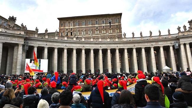 Faithfuls listen to Pope Francis deliver his speech from the Apostolic Palace overlooking St Peter's Square on January 6. Picture: AFP