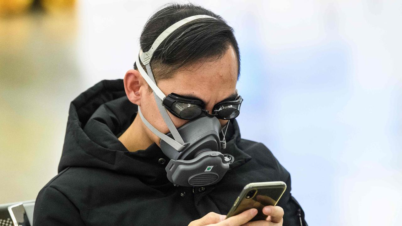 A man wears swimming goggles and a face mask at a Hong Kong train station Picture: AFP