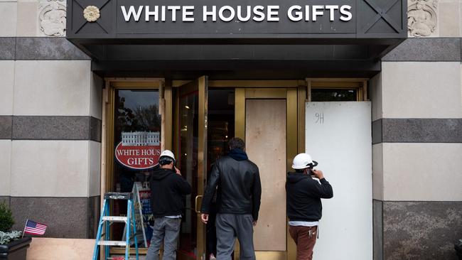 People board up the White House Gifts store, three days before the election. Picture: Andrew Caballero-Reynolds/AFP