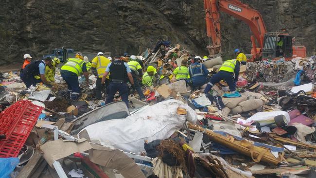 A large bulldozer was involved when tonnes of garbage were heaped on top of the men