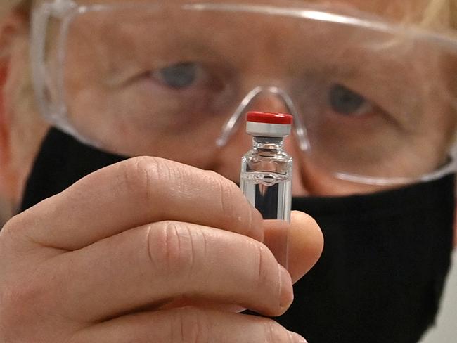 WREXHAM, WALES - NOVEMBER 30: UK Prime Minister Boris Johnson poses for a photograph with a vial of the AstraZeneca/Oxford University COVID-19 candidate vaccine, known as AZD1222, at Wockhardt's pharmaceutical manufacturing facility on November 30, 2020 in Wrexham, Wales.  The UK government announced a deal in August with global pharmaceutical and biotechnology company Wockhardt, to increase capacity in a crucial part of the manufacturing process for Covid-19 vaccines. Britain has been Europe's worst-hit country during the pandemic, recording more than 57,000 deaths from some 1.6 million cases.  (Photo by Paul Ellis - WPA Pool/Getty Images) ***BESTPIX***