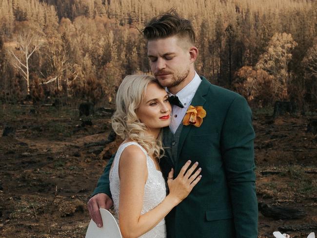 Couple shot:  Tiffany Hulm and Sean Duncan pose for pics after their wedding at  Bago State Forest on the outskirts of Tumbarumba on the NSW-Vic border in Feb 2020, five weeks after the Black Summer bushfires swept through. The forest is where Sean proposed to Tiffany a year earlier and where they initially planned to hold the ceremony. It is one of a series of shots from Fighting Spirit, a book collaboration between News Corp Australia, HarperCollins and the Federal Government, saluting the communities involved in the fires and their recovery.PIc: corinnaanddylan.com