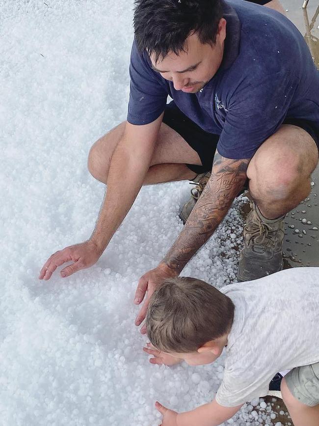 Dave Hill and his son enjoy the hail at Biloela. Picture: Renee Hill