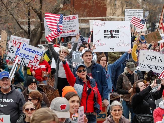 People protest against the coronavirus shutdown in front of the State Capitol in Madison, Wisconsin yesterday. Picture: AFP