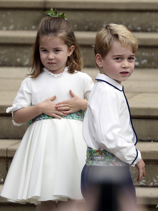 Prince George and Princess Charlotte arrive for the the wedding of Princess Eugenie of York and Jack Brooksbank at St Georgeâ€™s Chapel, Windsor Castle, near London, England, Friday Oct. 12, 2018. (Steve Parsons/Pool via AP)