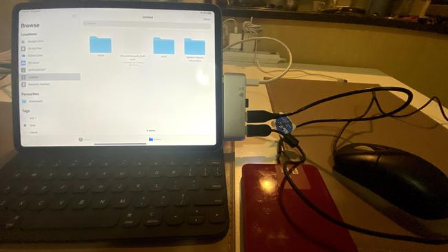 An iPad Pro with a mouse, external hard drive and micro SDcard connected via a USB-C adaptor. Pass through power is connected too. Picture: Chris Griffith