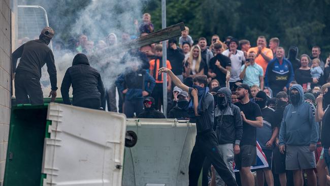 Anti-migration protesters, above, and below, attempt to enter the Holiday Inn Express Hotel in Rotherham. Pictures: Getty Images