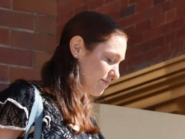 Jessica Hanbury, nee Polsoni, leaving Mackay Courthouse with her lawyer Adam Harvey on May 13, 2024. She and husband Adam Hanbury are both charged with one count of murder over the death of their daughter Diana Hanbury in 2022.Â 