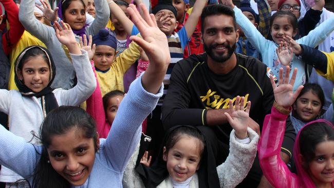 Students at the Guru Nanak Punjabi School greet Amritpal Singh.