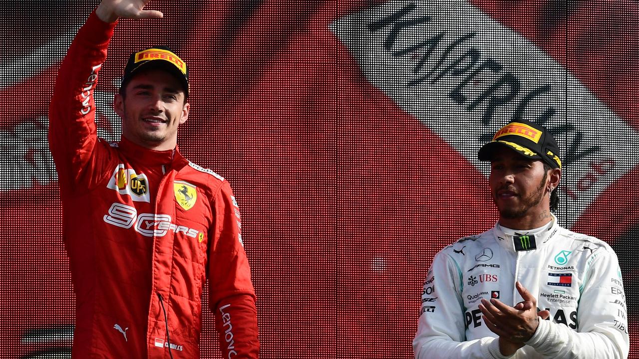 Charles Leclerc (L) celebrates next toLewis Hamilton on the podium in Monza.