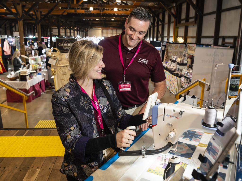 American visitors Janessa Kimball and Nathan Erznoznik of The Grace Company demonstrate quilting machines at Craft Alive at the Goods Shed, Saturday, May 21, 2022. Picture: Kevin Farmer