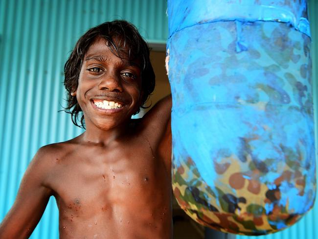 Local Minyerri child Sampson Farrell, 9, works out on the punching bag. The Minyerri community is located 480kms from Darwin, NT. Picture: Justin Kennedy