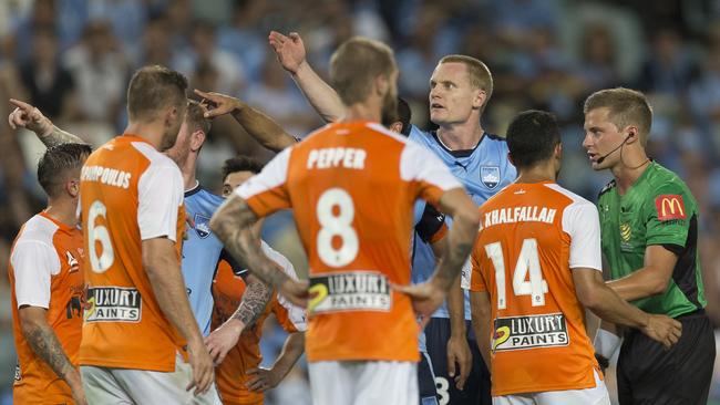 Sydney FC players point to the replay after a scuffle broke out when Matt Simon of claimed Avram Papadopoulos spat at him. Photo: AAP