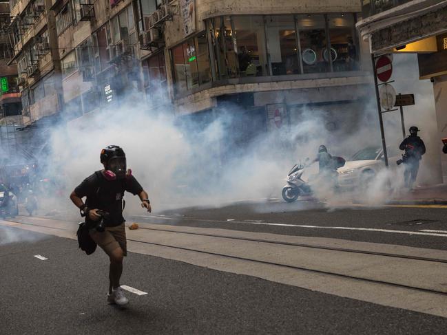 Riot police deploy tear gas as they clear protesters. Picture: AFP