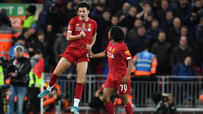 Liverpool midfielder Curtis Jones, left, celebrates after scoring against Everton in their FA Cup third round match at Anfield. Picture: AFP