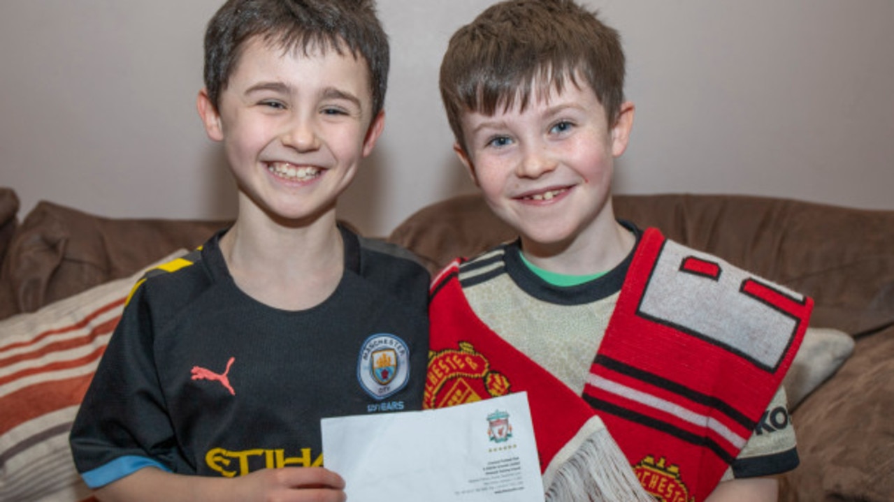 United fan Daragh Curley and his brother Dylan pose with his letter from Klopp