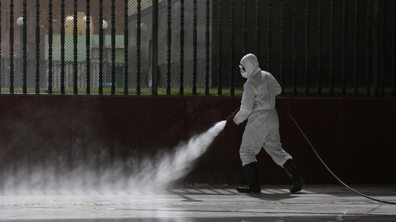 Iraqi workers spray disinfectant as a precaution against the coronavirus in the shrine of Imam Ali in Najaf, Iraq. Picture: Anmar Khalil/AP