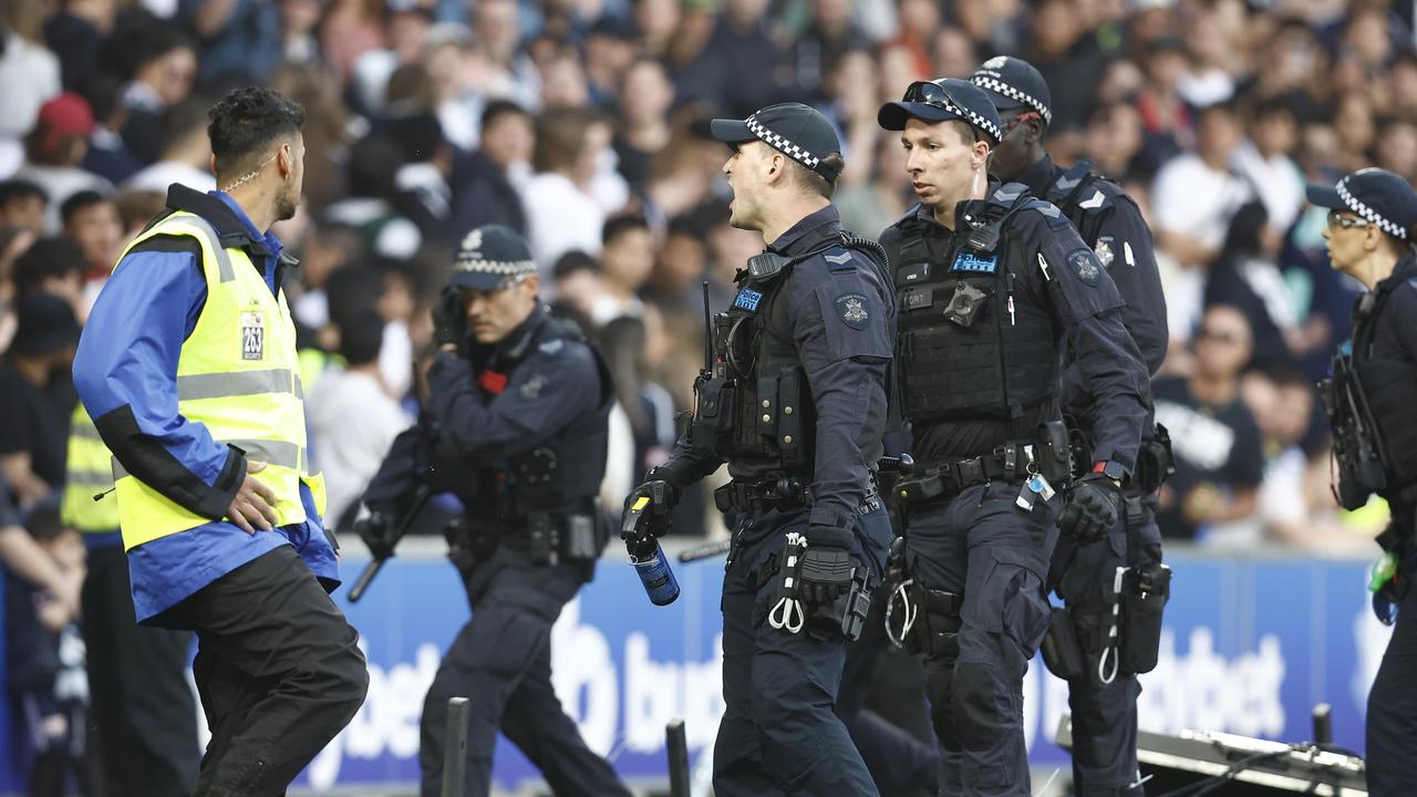 Members of Victoria Police struggle to restore order as Australian soccer plummeted to new depths. Picture: Darrian Traynor/Getty Images