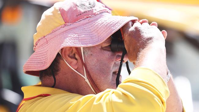 A lifesaver watches over beachgoers at Burleigh on Sunday. Picture: Jason O'Brien