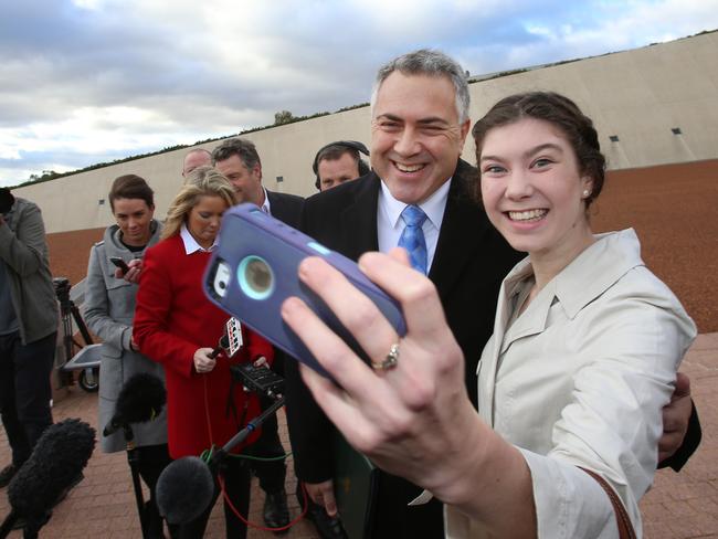 He’s still got a fan ... Anika Buining from the Hunter Valley took the opportunity for a selfie with Joe Hockey this morning as he talked with the media. Picture: Gary Ramage