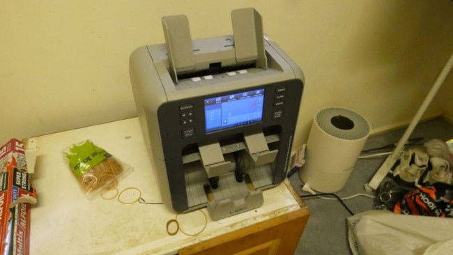 A cash counting machine found in Urquhart’s unit. Picture: Supplied/OPP