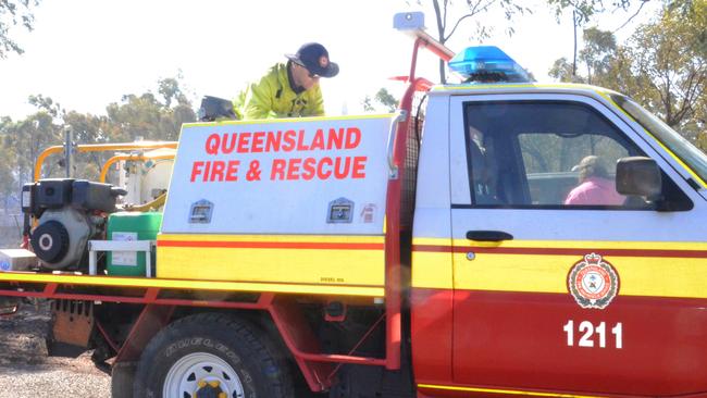 Queensland Fire and Emergency Services officer Peter Orchard fills the mobile fire unit with water from Agripower with the help of Agripower employee Glenn Walker. Picture: Trudy Brown