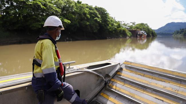 A TotalEnergies worker on the boat from Herd Base to the Purari Airstrip along the Purari River. Boats and helicopters are the only way in and out of Herd Base, which will be the staging ground for the Papua LNG project.