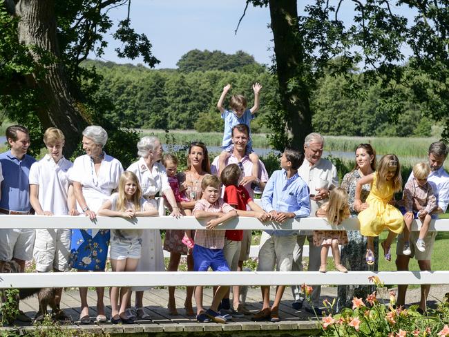 The Danish royals posed for the media on a wooden footbridge within the grounds,