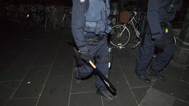 Police seize a baseball bat found on one of the youths. Picture: Jason Edwards