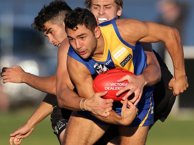 Ben Cavarra tries to break a tackle in the VFL. Picture: Yuri Kouzmin