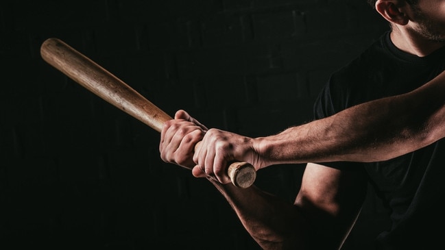 cropped shot of young man playing baseball with bat isolated on black Photo: iStock