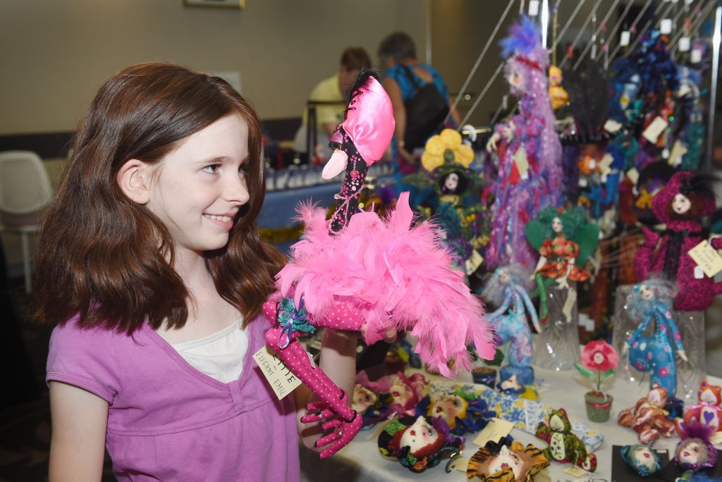 Ashleigh Garrett with Ettie the elegant emu at the Hervey Bay Crafters Christmas Craft Fair. Picture: Valerie Horton