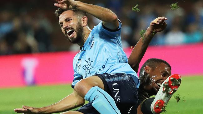 Wanderers’ Rashid Mahazi brings down Sydney’s Michael Zullo.