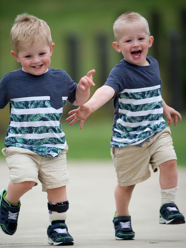 Beau Clarkson (right) has a sock on his left foot in support of twin brother Bailey, who wears a leg brace. Picture: Jay Town