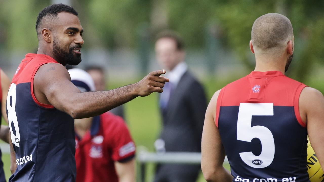 Heritier Lumumba (left) shares a joke with team mate Jimmy Toumpas during Melbourne Demons AFL training at Gosch's Paddock on Tuesday, March 3, 2015, in Richmond, Australia. Picture: Hamish Blair