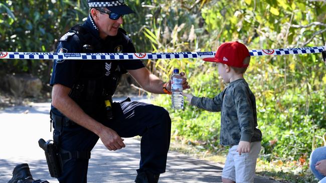 J.J Kelly, 3, from Caloundra hands out a bottle of water to Sgt Phillip Stevens on duty at the Peregian fires.